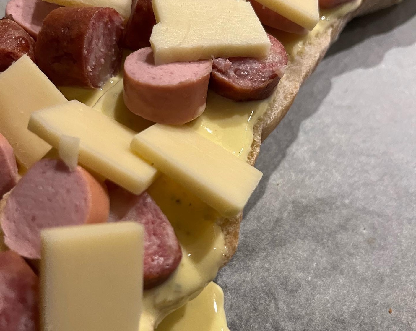 Schritt 4 Dann mit Wurstscheiben, Käsewürfeln und Zwiebelringen belegen. Paprikapulver (wenig) darüber streuen.