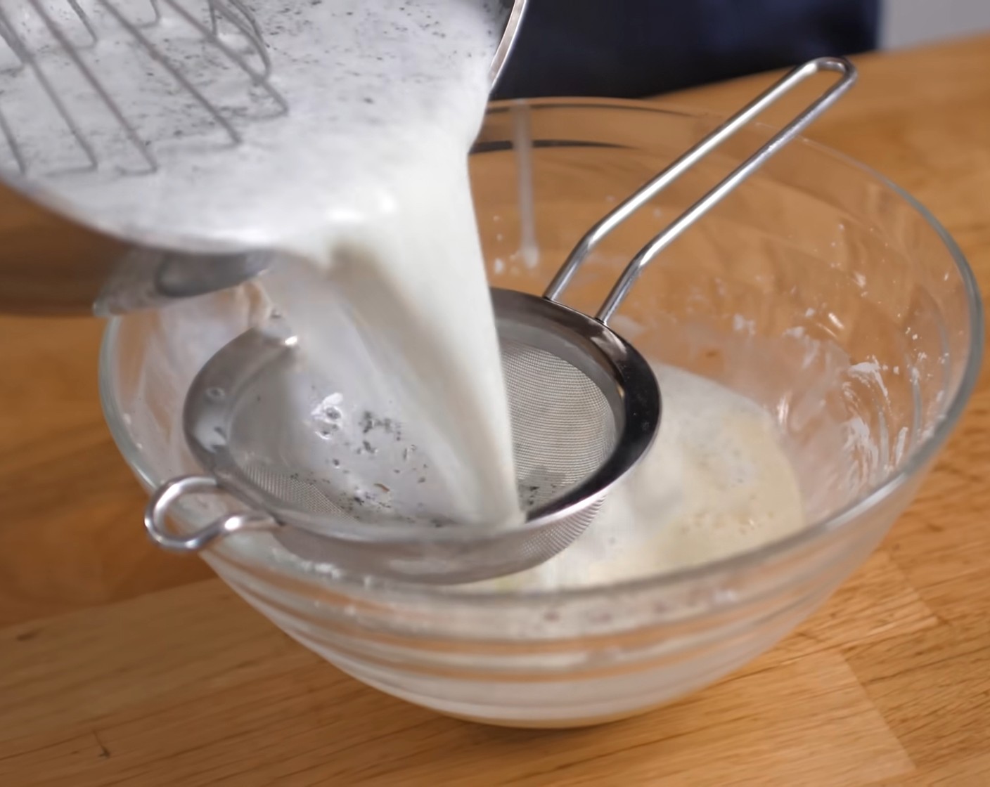 Schritt 3 Die Milch auf dem Herd aufkochen und danach durch ein Sieb zur Stärkemasse geben und alles zusammen glattrühren.