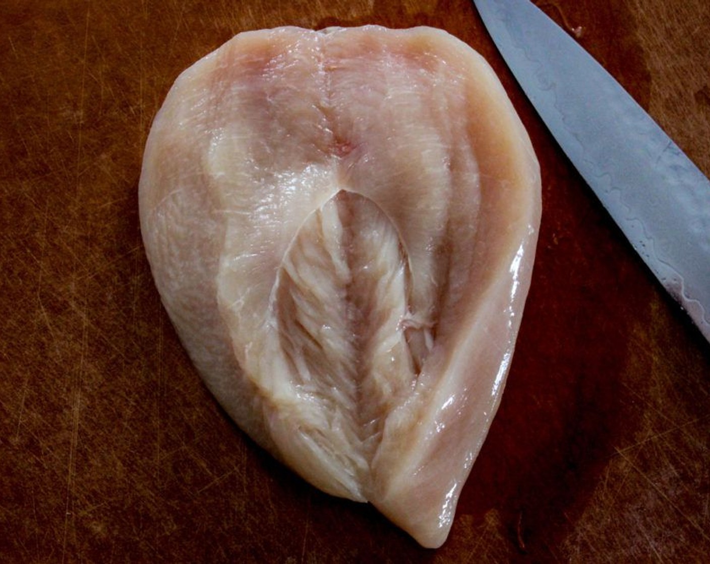 Schritt 4 Pouletbrust (2) auf das Schneidebrett legen und horizontal flach aufschneiden.