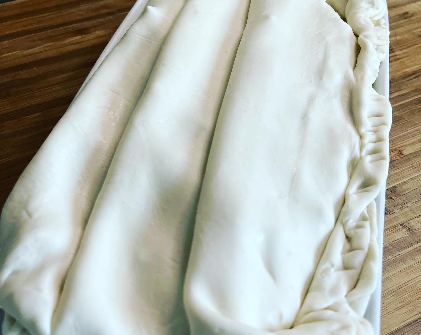 Schritt 4 Die Masse in die Gratinform geben und mit dem Teig decken.