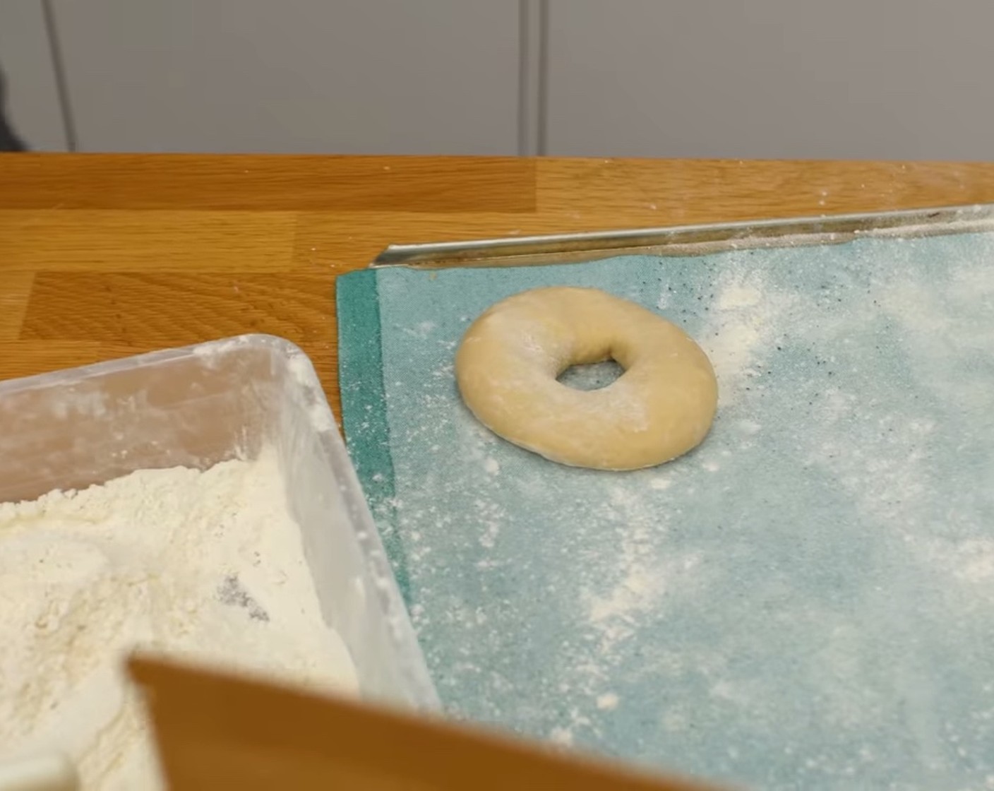 Schritt 7 Die Teigringe auf ein mit Mehl gestaubtes Teigtuch absetzen und nochmals etwas in Form bringen.