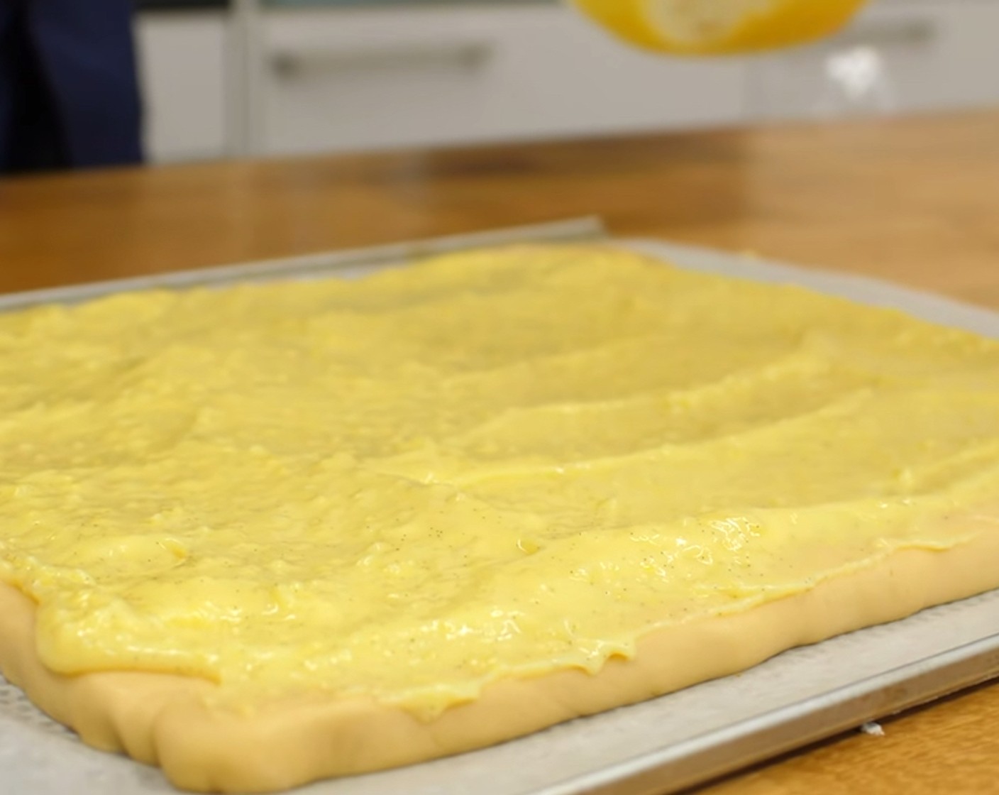 Schritt 18 Als nächstes die Creme gleichmässig auf dem vorbereiteten Teigboden verteilen und mit einer Teigkarte verstreichen.