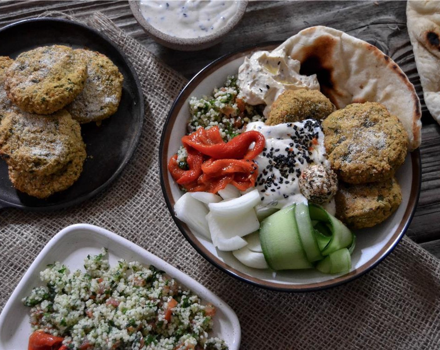 Schritt 6 Couscous (wenig), Peperoni (wenig), Gurkenstreifen, Zwiebel (1), Labneh (wenig) in einer Bowl anrichten. Fladenbrot (wenig) und Falafel ebenfalls in der Bowl anrichten. Mit einem Klecks Hummus (wenig) garnieren.